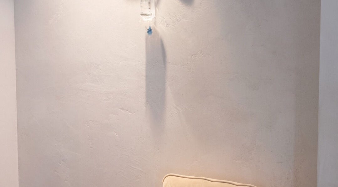 Minimalist lounge area at Rewind, Currumbin Waters, Queensland, AU with a soft beige couch.