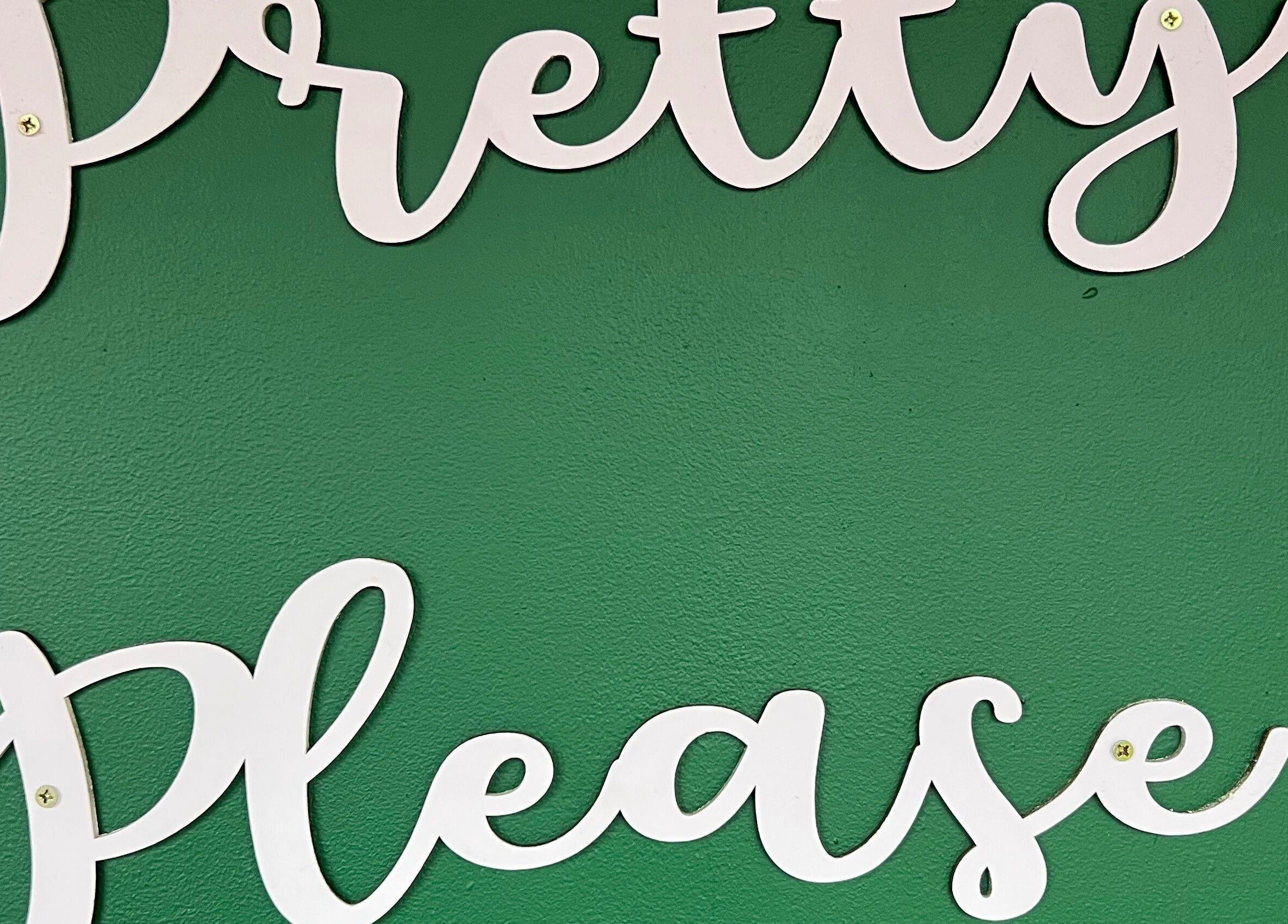 Pretty Please logo on a green wall at the venue in Bristol, England, GB.