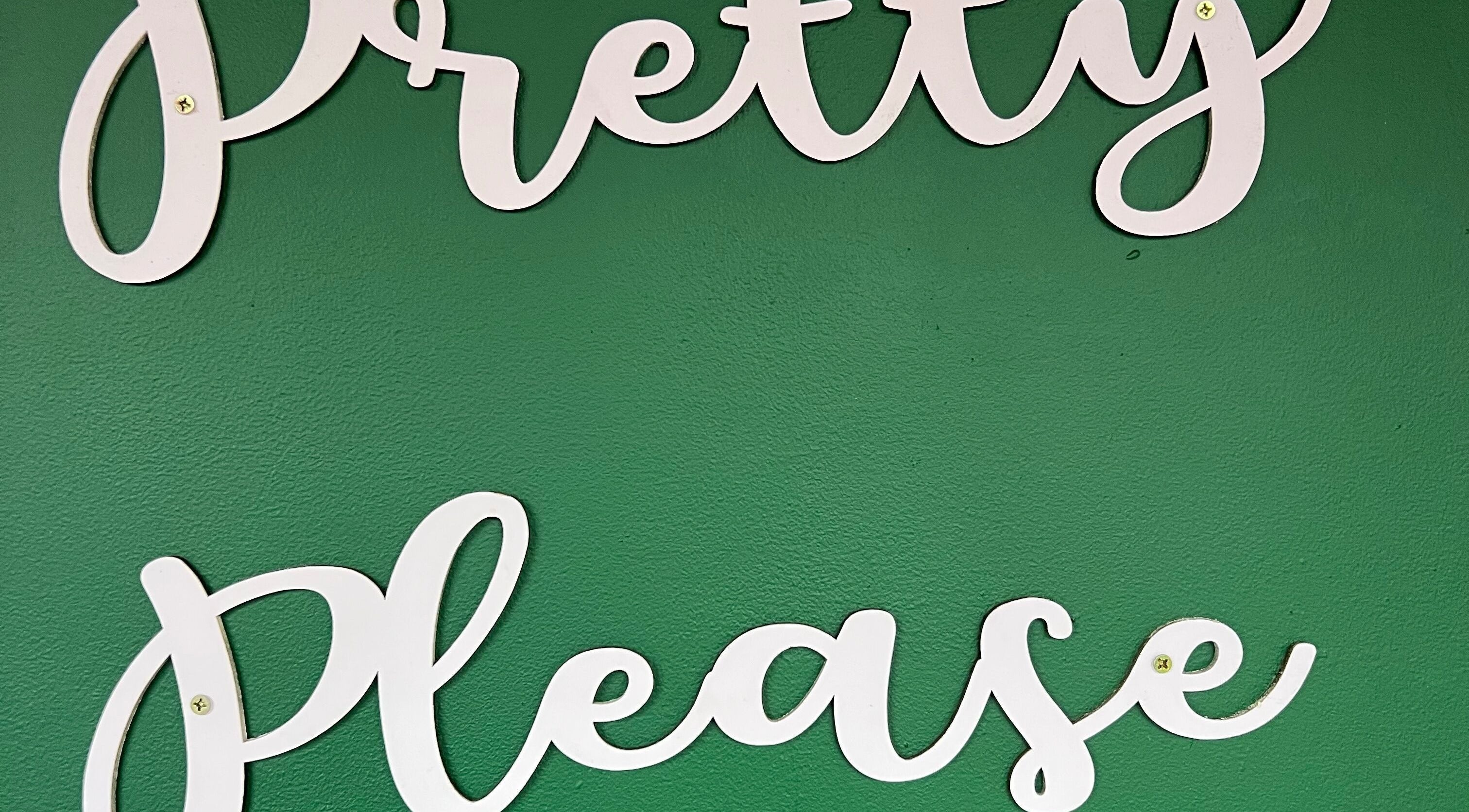 Pretty Please logo on a green wall at the venue in Bristol, England, GB.
