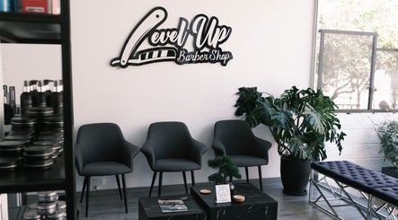 Modern waiting area at Level Up Barber Shop, Egkomi, Nicosia, CY with sleek decor and comfy seating.