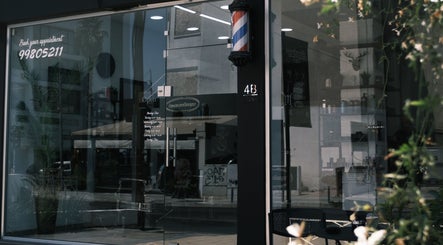 Entrance to Level Up Barber Shop in Egkomi Nicosia CY with modern glass facade.
