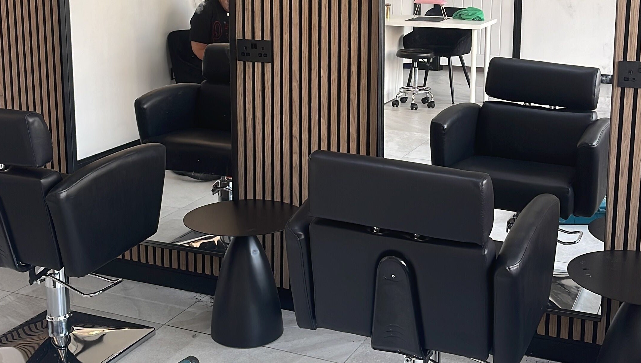 Modern salon chairs and mirrors at Glow Salon in Salford, England, GB, reflecting luxury and comfort.