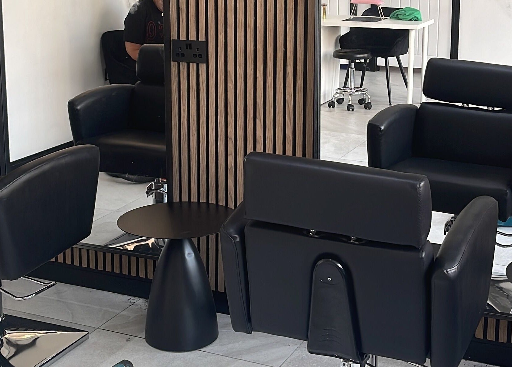 Modern salon chairs and mirrors at Glow Salon in Salford, England, GB, reflecting luxury and comfort.