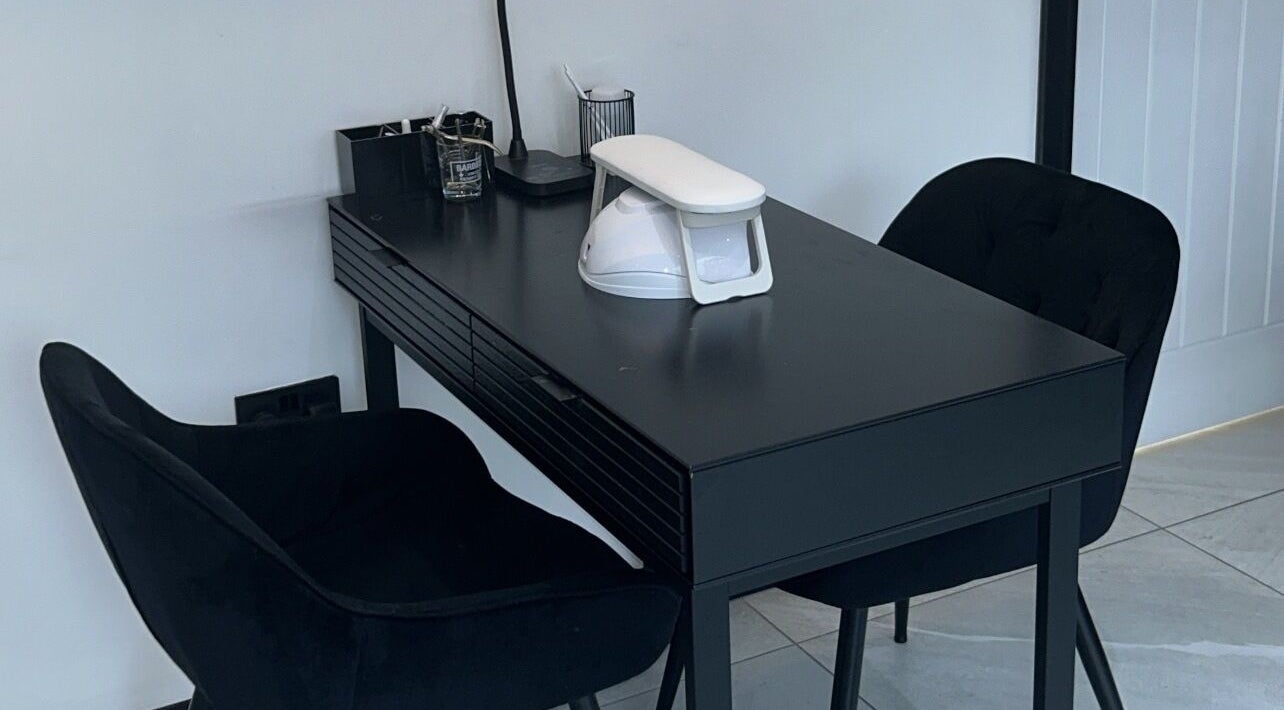 Sleek black manicure station at Glow Salon, Salford, England, GB, with black chairs and modern nail equipment.