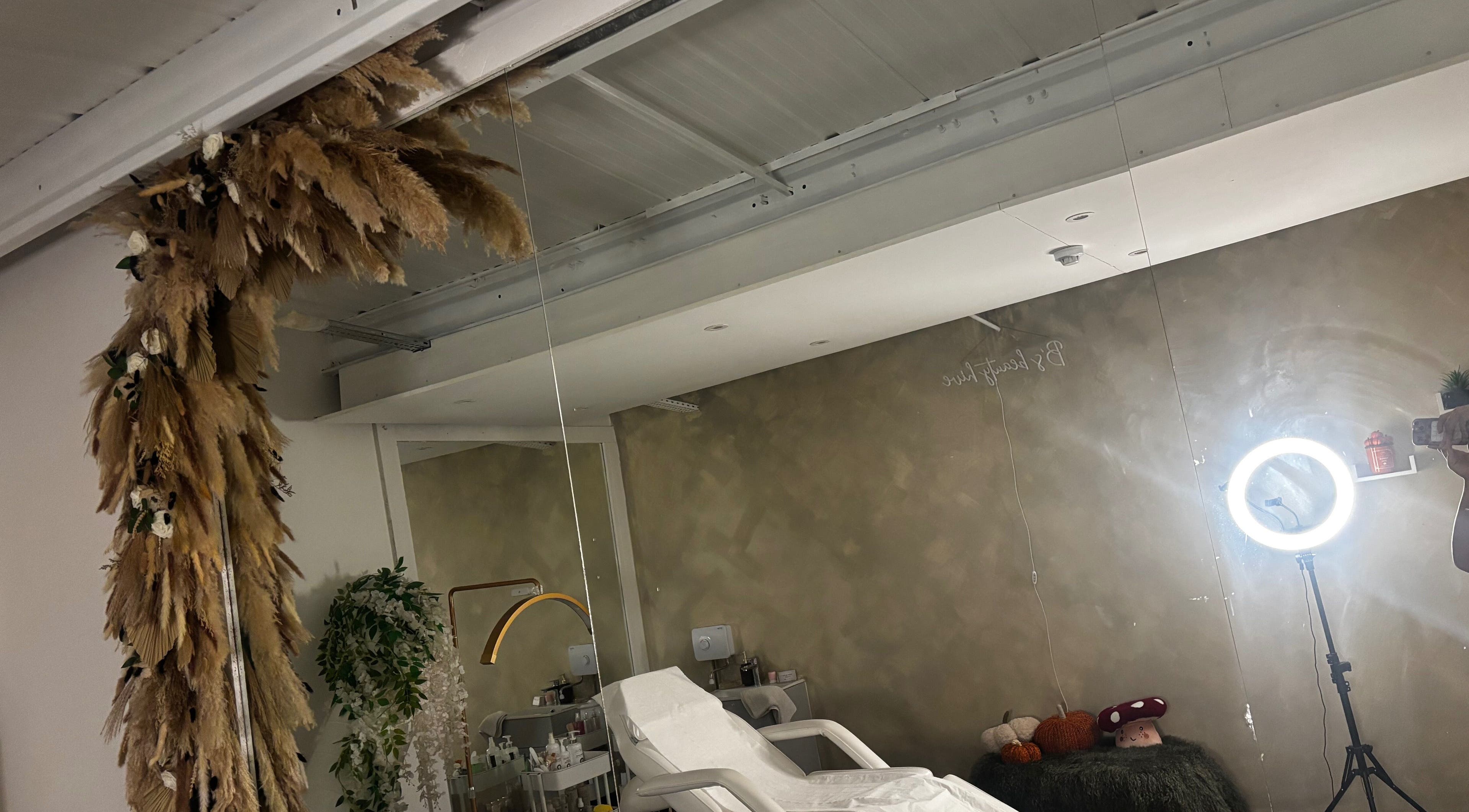 Chic treatment space at B’s Beauty Hive, Cardiff, Wales, GB, featuring a massage chair and elegant decor.