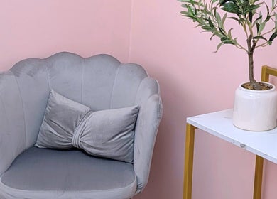 Elegant grey chair with plant at New Age Aesthetics, Doncaster, England, GB.