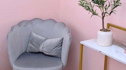 Chic seating area at New Age Aesthetics in Doncaster, England, GB featuring a grey chair and decorative plant.