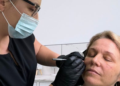 Beauty professional performing treatment at New Age Aesthetics, Doncaster, England, GB.