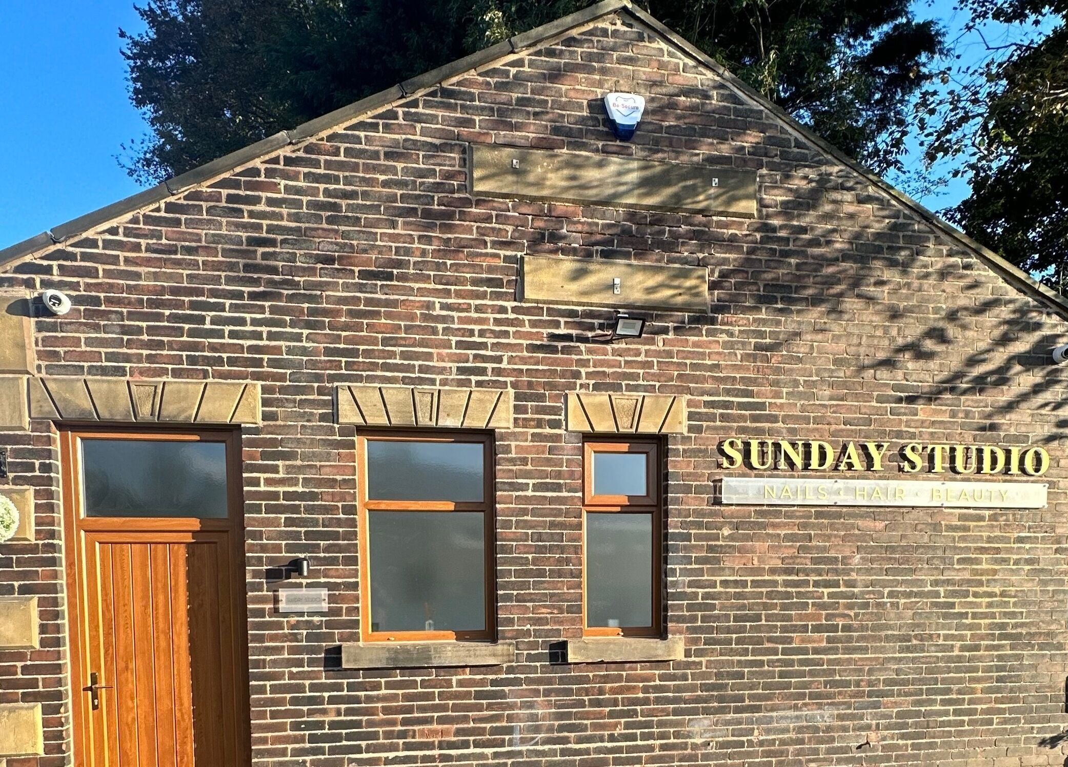 Exterior of Sunday Studio, Horbury, Wakefield, England, showcasing brickwork and signage.