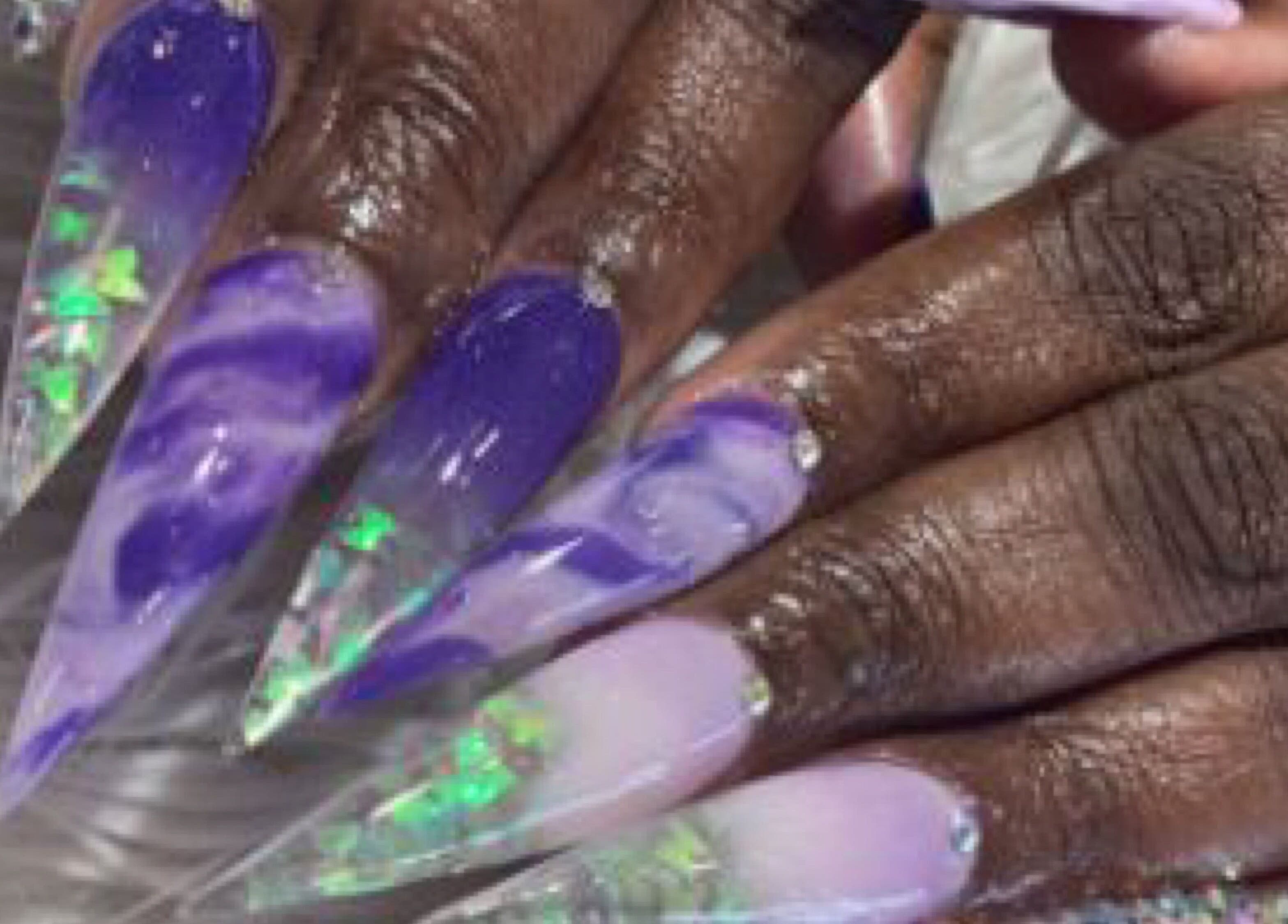 Vibrantly painted marble nails with gems at Palace Nails, Bowling Green, Kentucky, US.