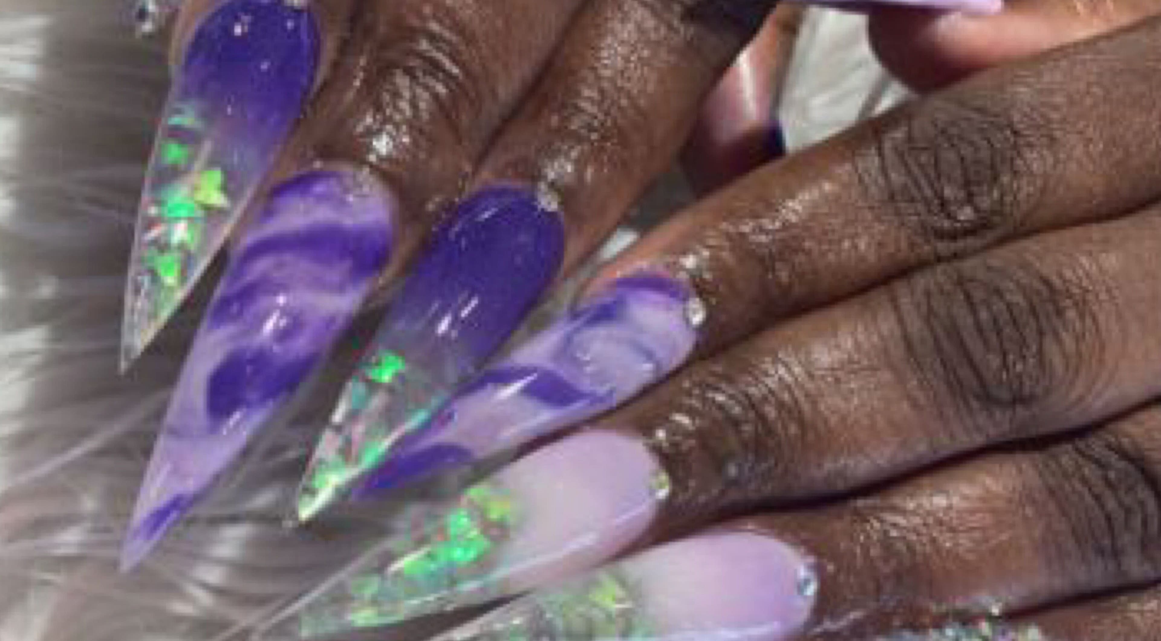 Vibrantly painted marble nails with gems at Palace Nails, Bowling Green, Kentucky, US.