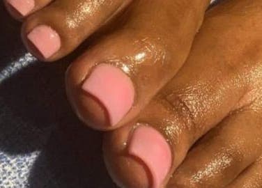 Elegant pink pedicure from Palace Nails in Bowling Green, Kentucky, US, highlighting shiny, well-groomed toes.