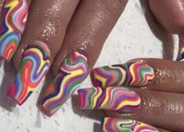 Vibrant rainbow swirl nail art at Palace Nails in Bowling Green, Kentucky, US for colorful styling.
