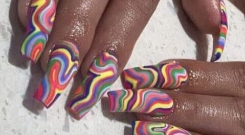 Vibrant rainbow swirl nail art at Palace Nails in Bowling Green, Kentucky, US for colorful styling.