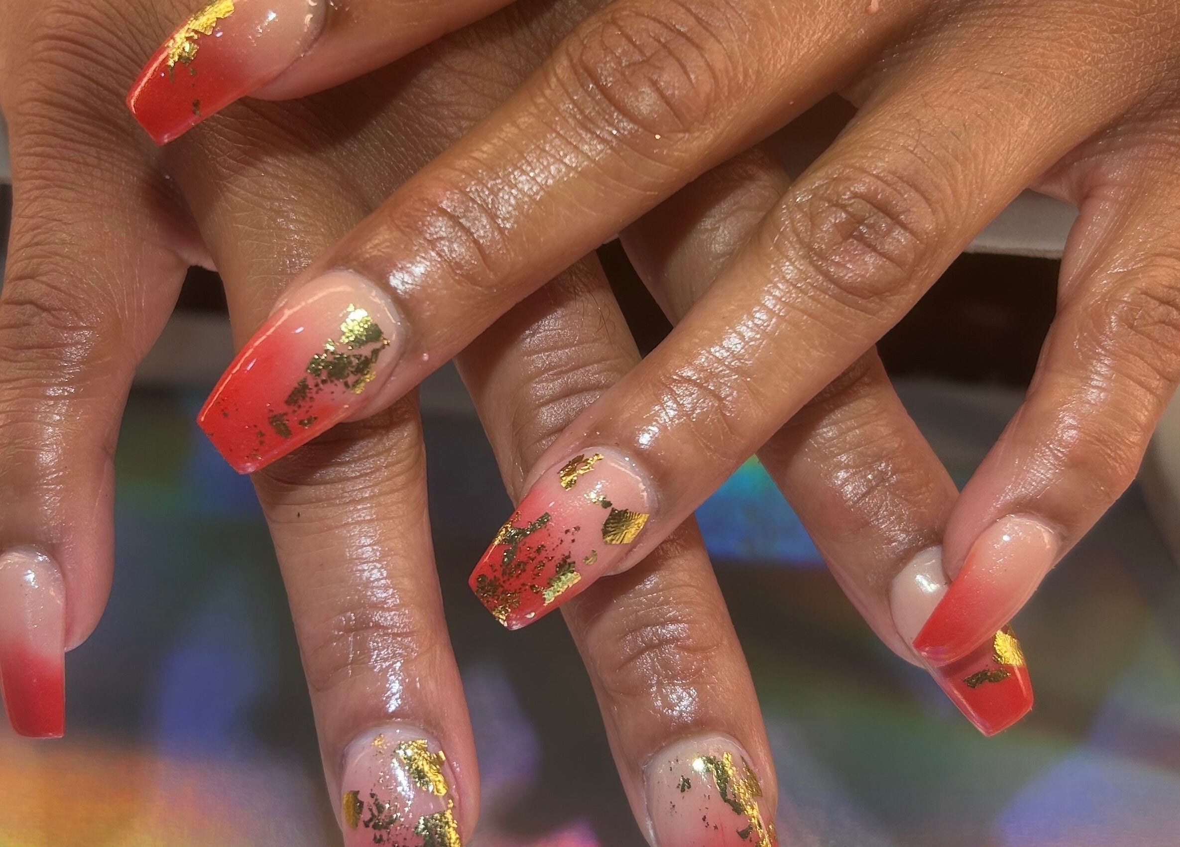 Glamorous red and gold nail art at Palace Nails, Bowling Green, Kentucky, US.