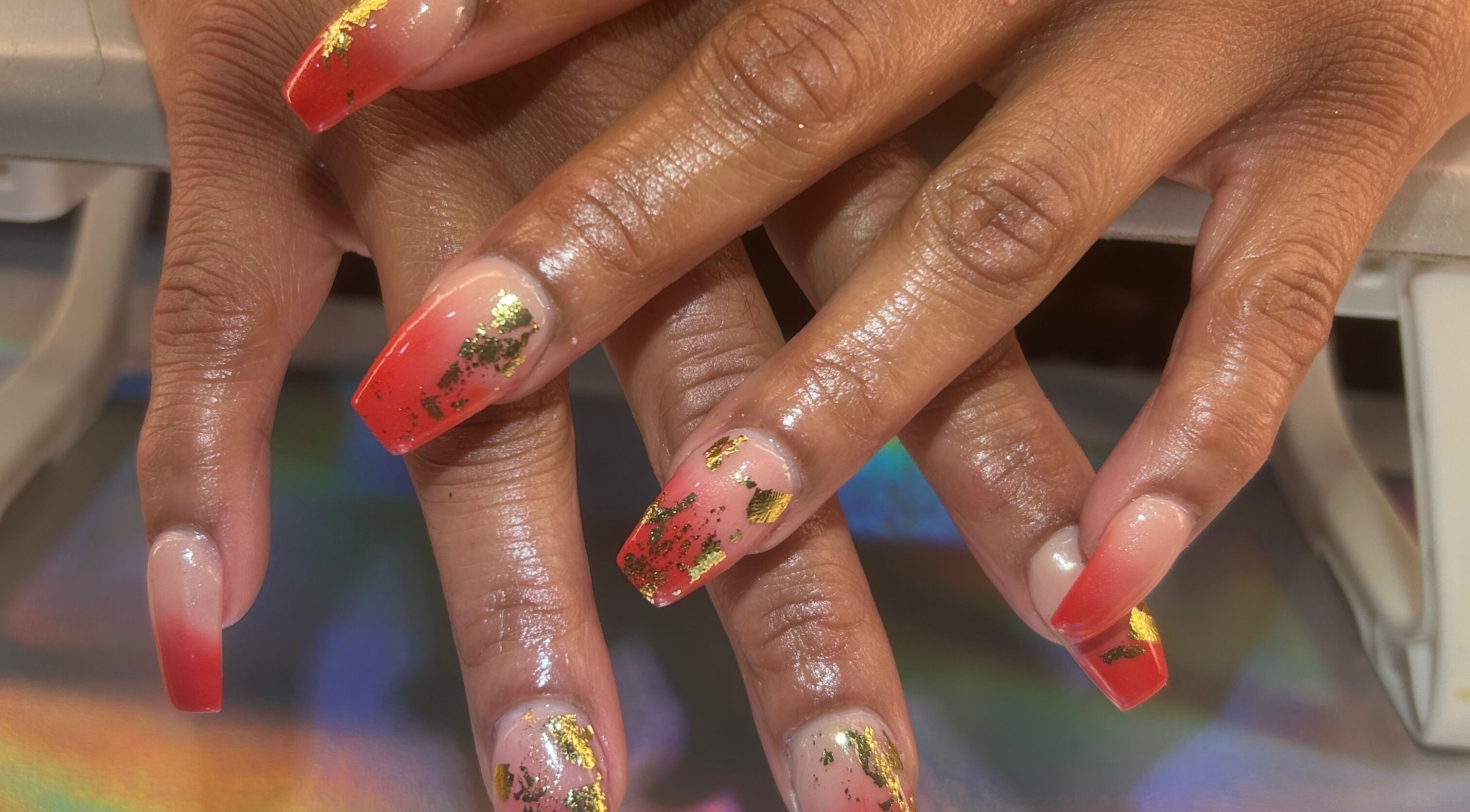 Glamorous red and gold nail art at Palace Nails, Bowling Green, Kentucky, US.