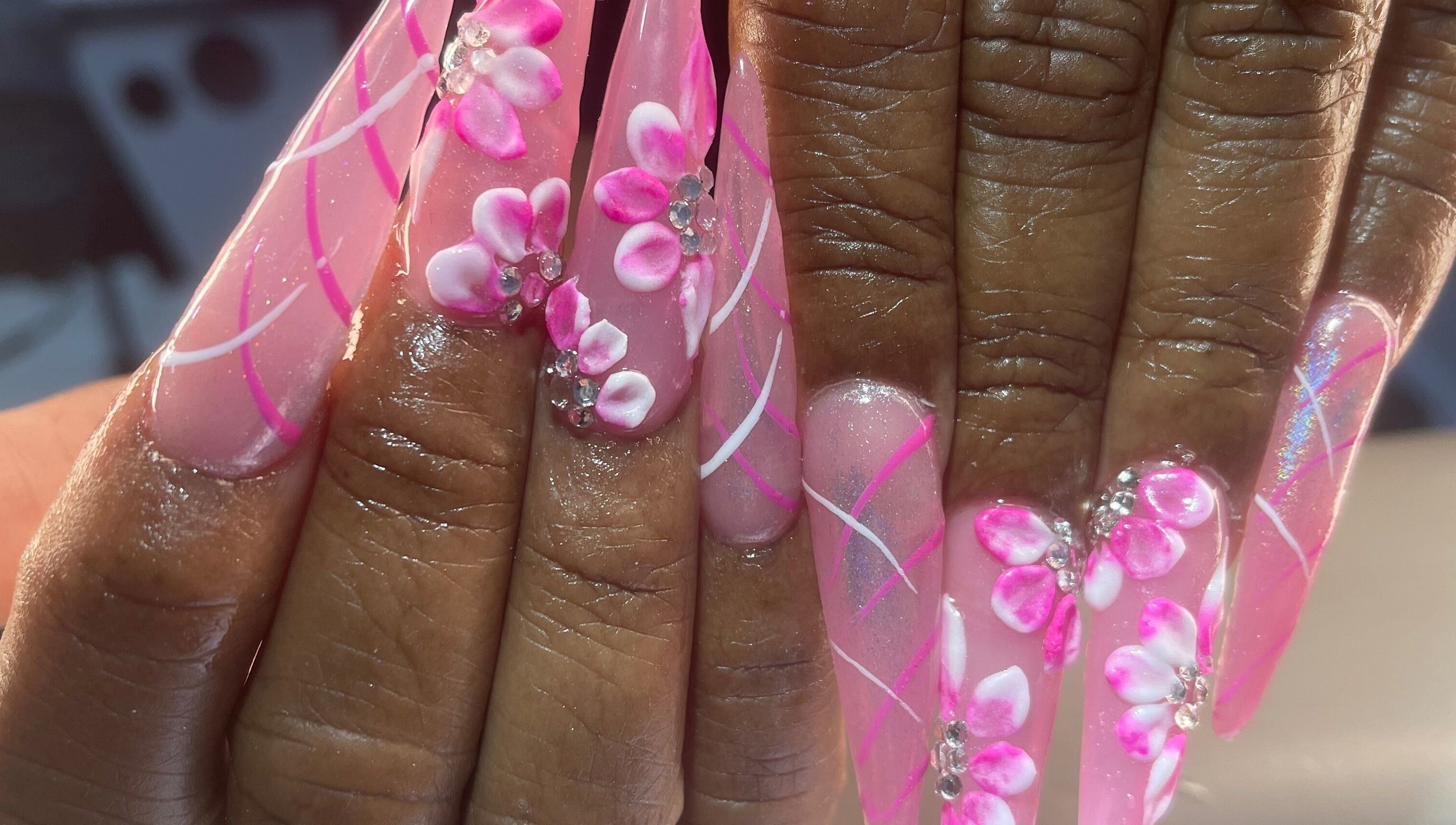 Elegant pink floral nail art at Palace Nails, Bowling Green, Kentucky, US. Detailed 3D designs with gems.