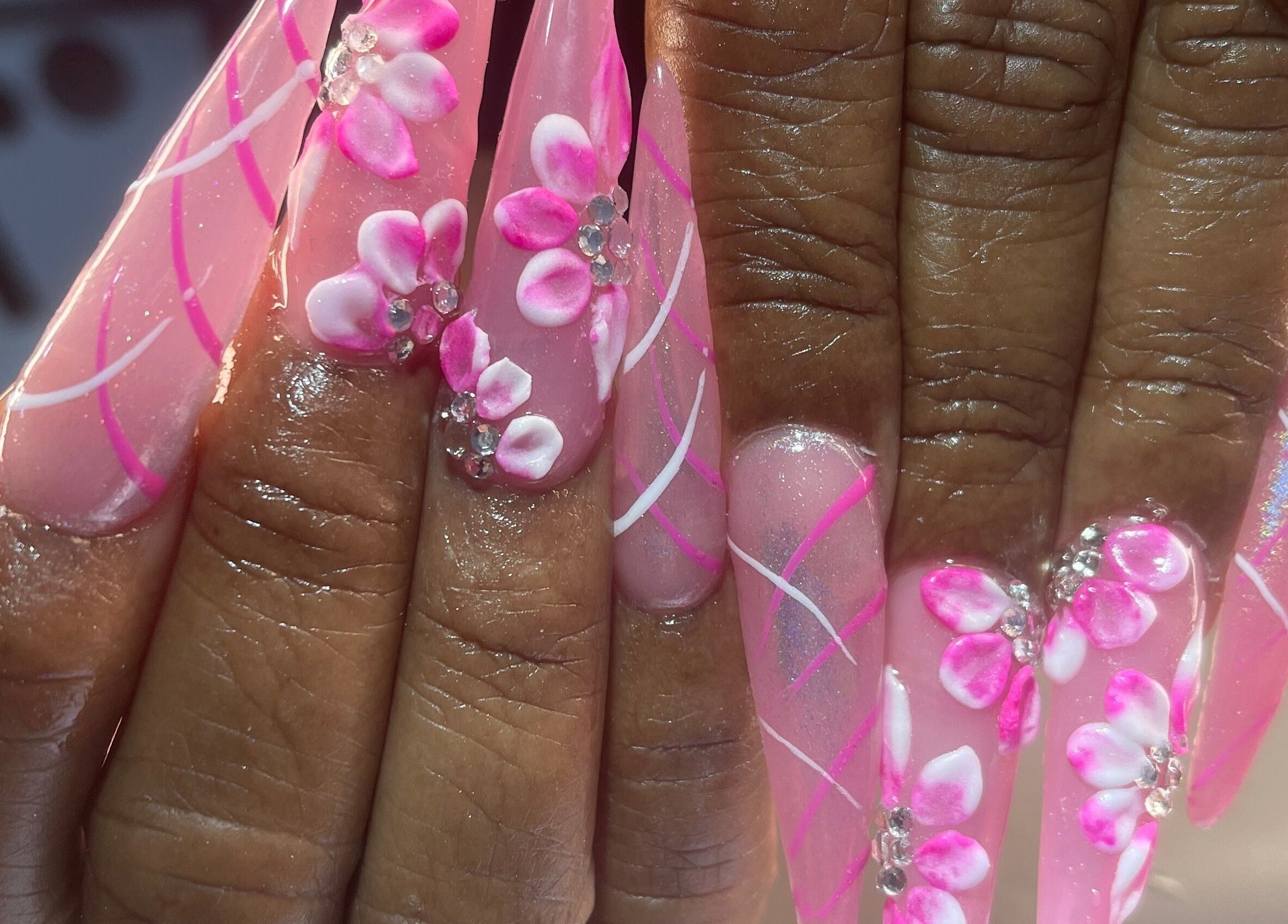 Elegant pink floral nail art at Palace Nails, Bowling Green, Kentucky, US. Detailed 3D designs with gems.