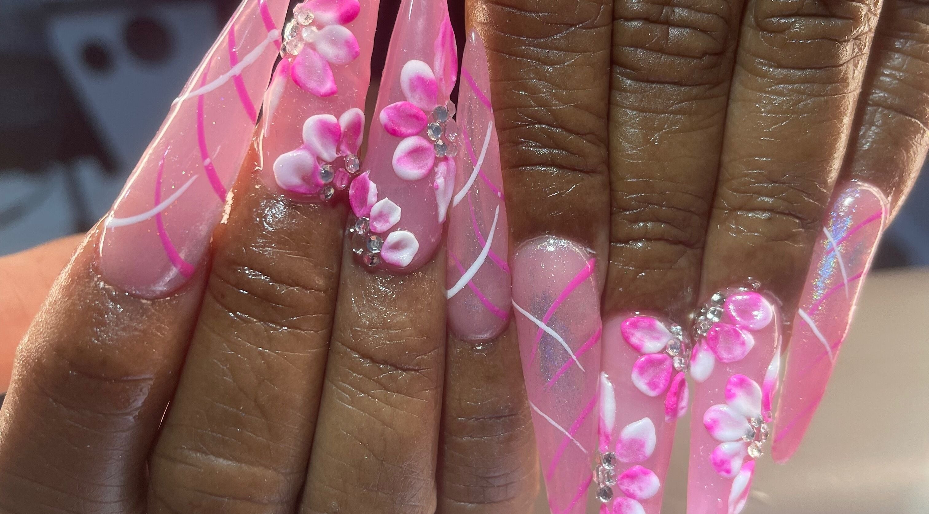 Elegant pink floral nail art at Palace Nails, Bowling Green, Kentucky, US. Detailed 3D designs with gems.