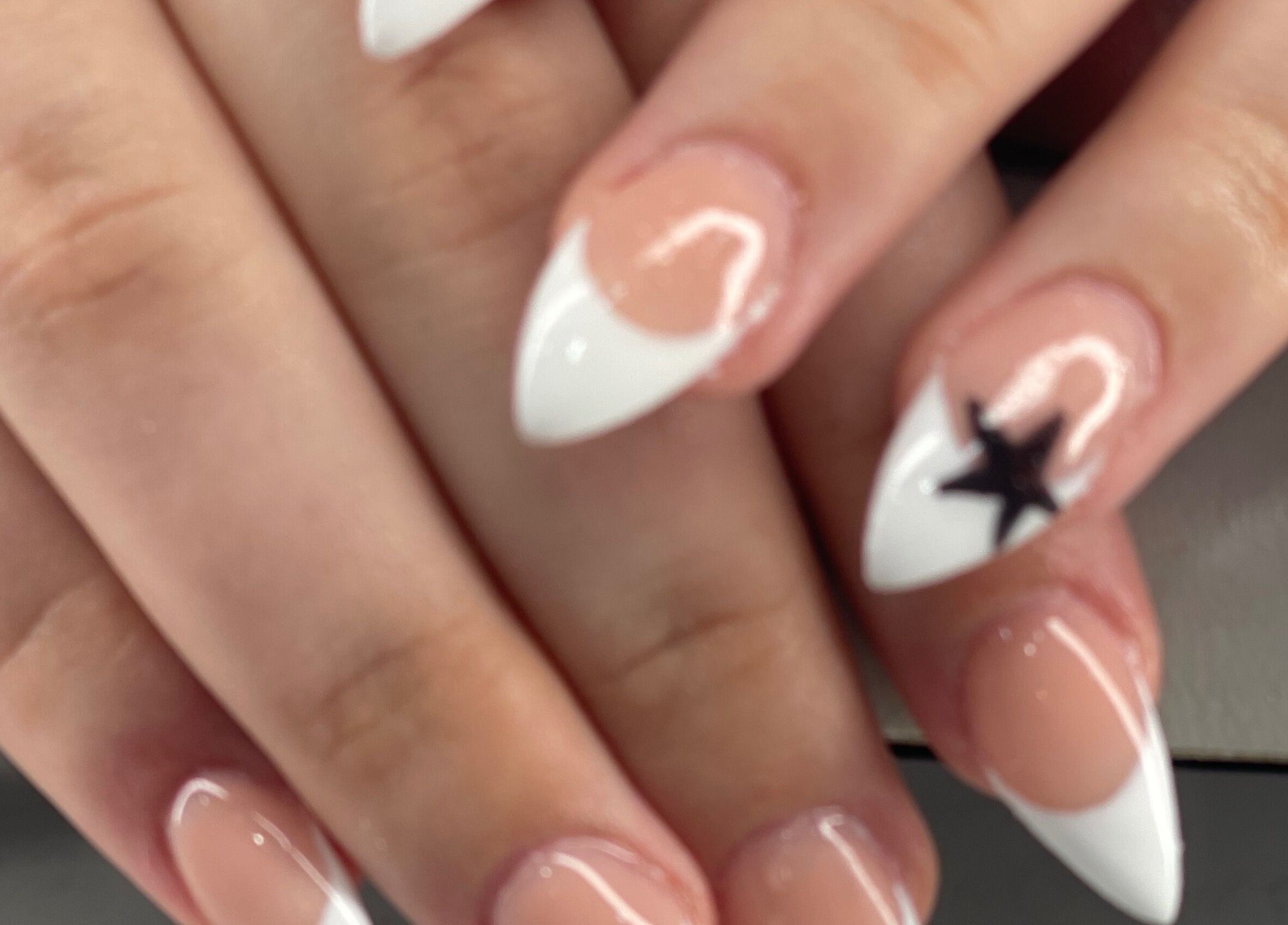 Elegant white-tipped nails with a star design at Palace Nails, Bowling Green, Kentucky, US.