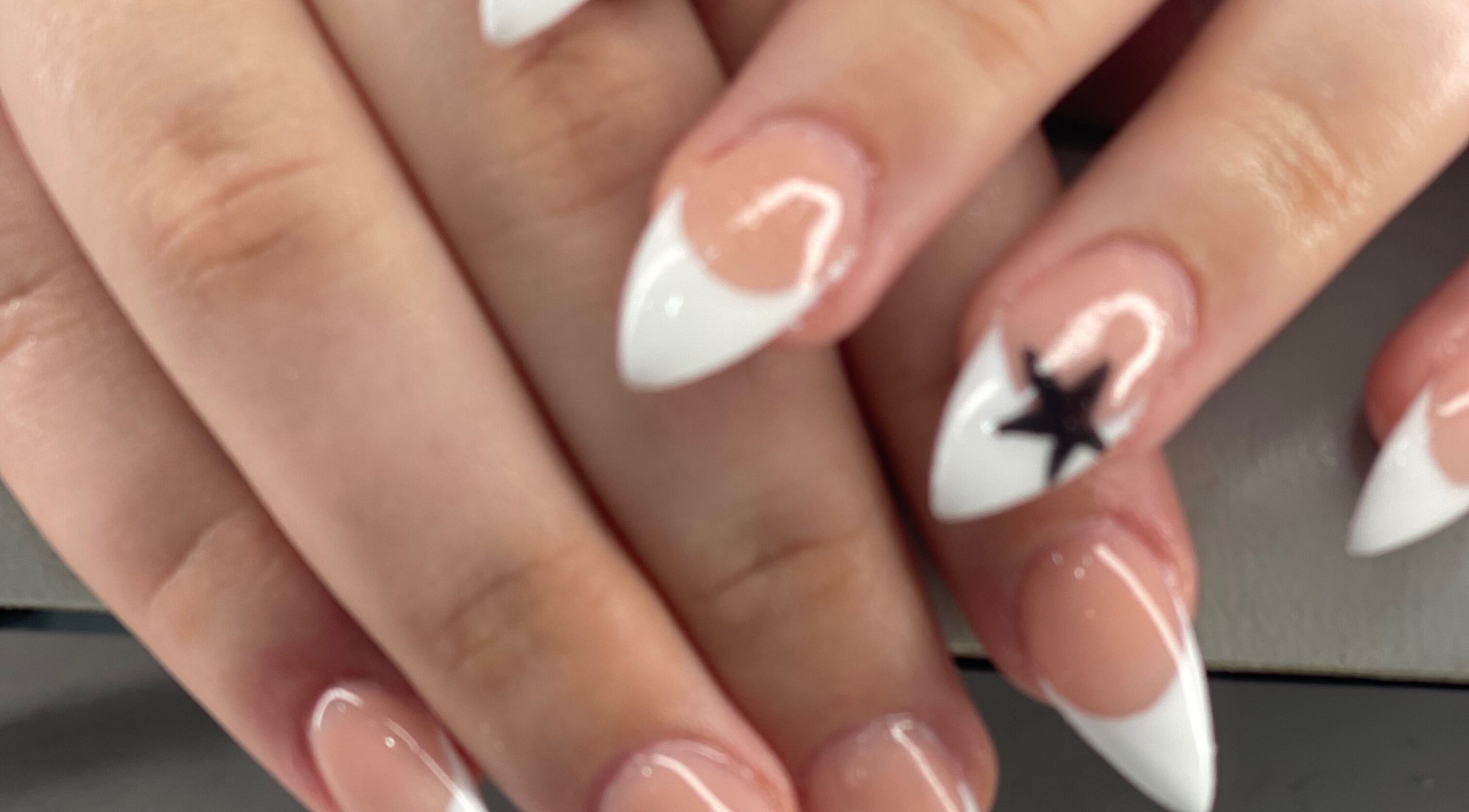 Elegant white-tipped nails with a star design at Palace Nails, Bowling Green, Kentucky, US.