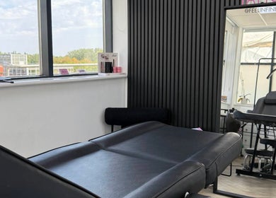 Beauty treatment room at Feelin Fine UK in Milton Keynes, England, GB with elegant black decor and large windows.