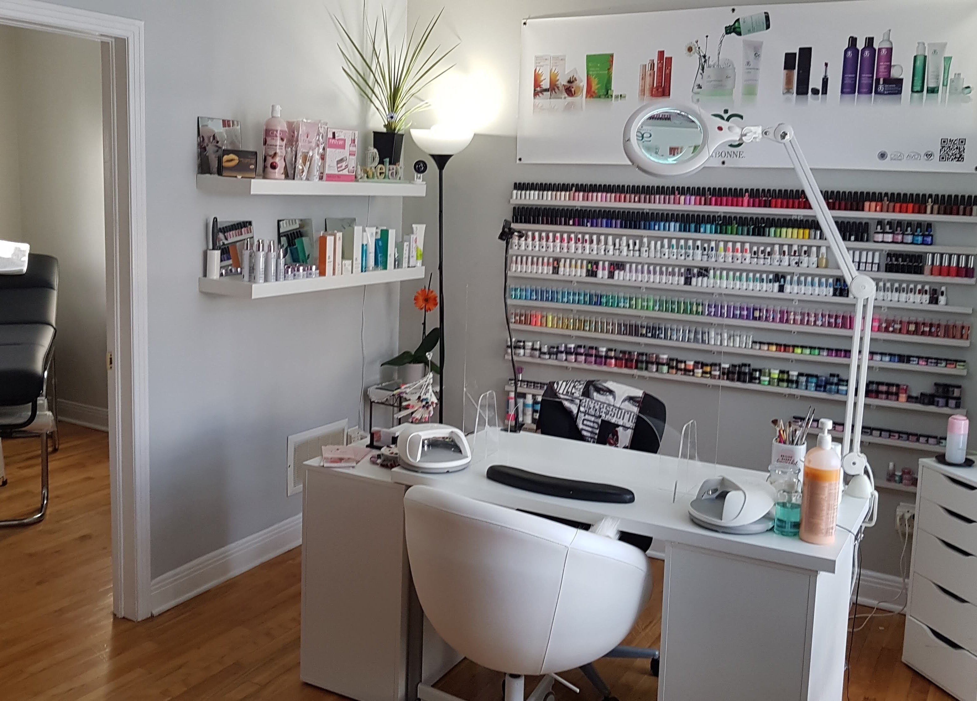 Chic nail salon at T.C. Spa, Ottawa, Ontario, CA, featuring a stylish manicure station with colorful polish display.