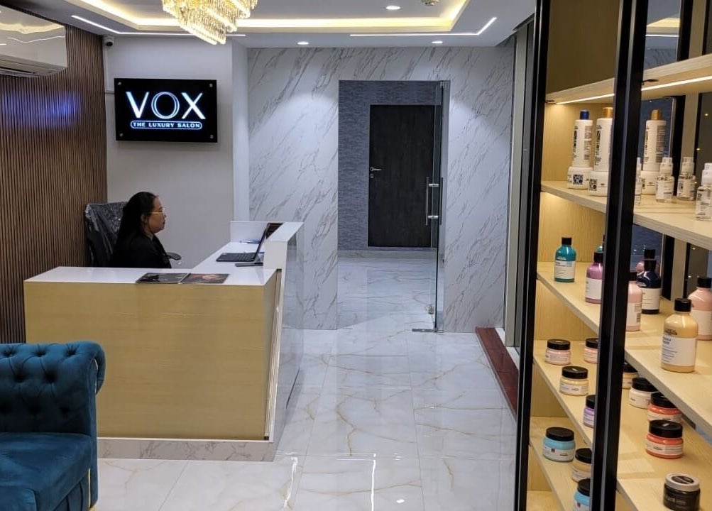 Elegant reception area at VOX - The Luxury Salon, Hyderabad, Telangana, IN, showcasing modern design and product display.