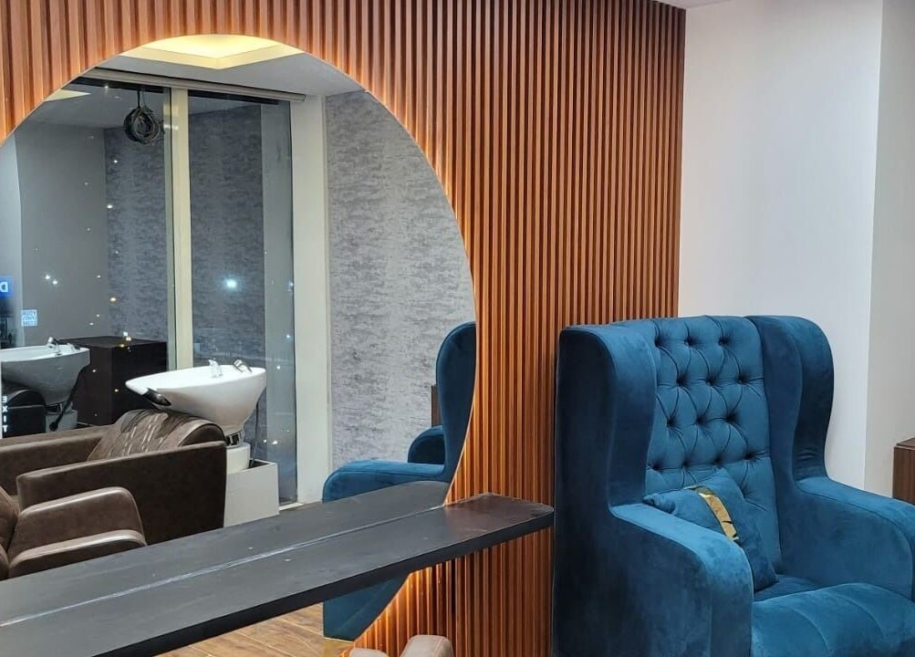 Luxurious seating at VOX - The Luxury Salon in Hyderabad, Telangana, IN featuring plush blue and brown chairs.