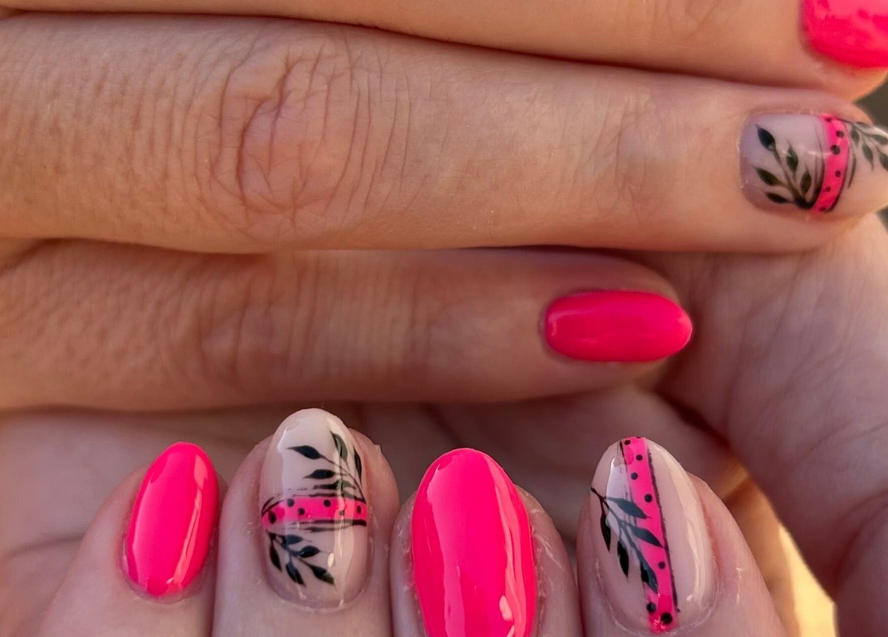 Blooming Nails in Tzaneen, Limpopo, ZA showcases vibrant floral nail art in stunning pink and black designs.