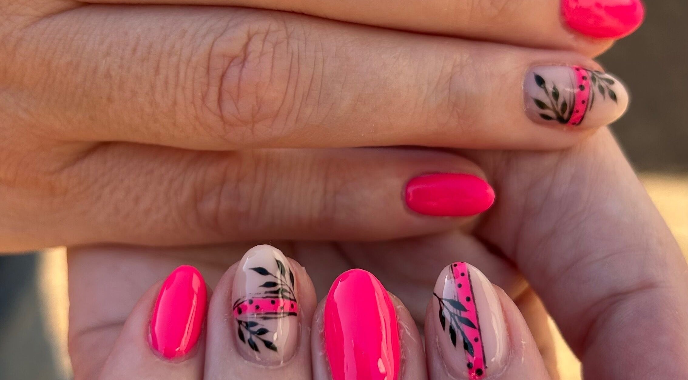 Blooming Nails in Tzaneen, Limpopo, ZA showcases vibrant floral nail art in stunning pink and black designs.