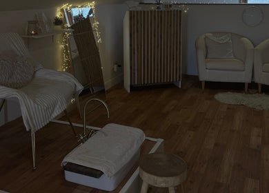 Inviting relaxation area at K.C Beauty, Culloden Moor, Scotland, GB featuring elegant seating and warm decor.