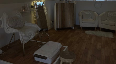 Inviting relaxation area at K.C Beauty, Culloden Moor, Scotland, GB featuring elegant seating and warm decor.