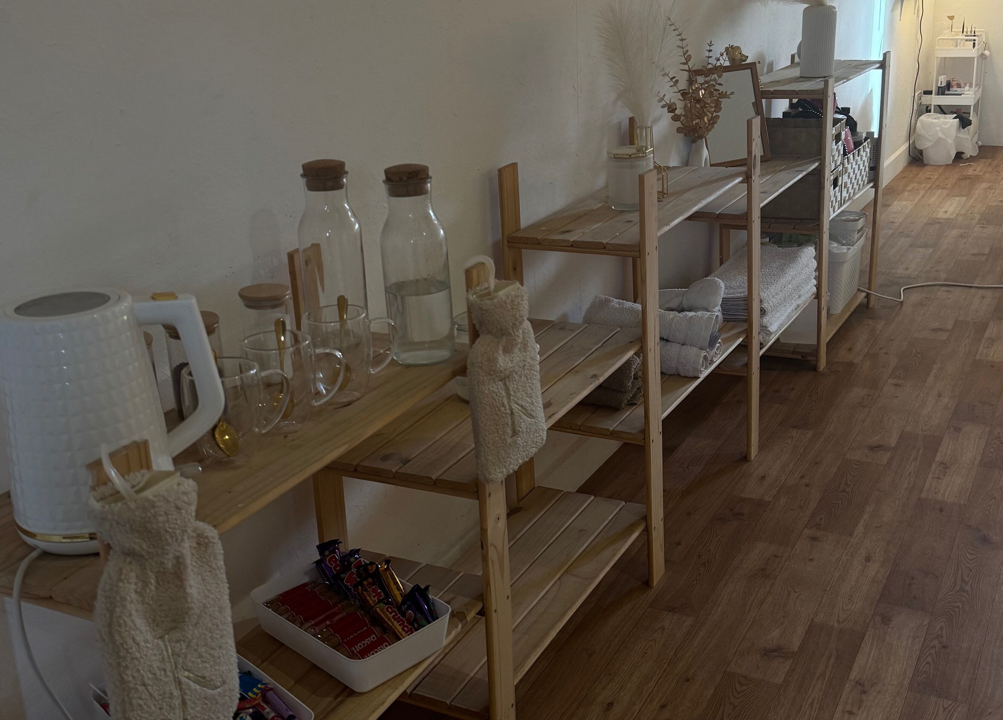 Wooden shelves with glassware and towels at K.C Beauty, Culloden Moor, Scotland, GB enhancing relaxation.