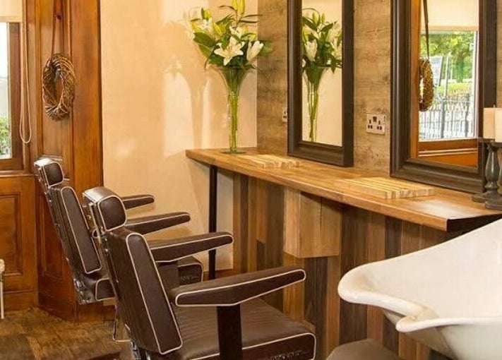 Elegant salon interior at Park West Spa, Hamilton, Scotland, GB featuring brown chairs and wooden decor.