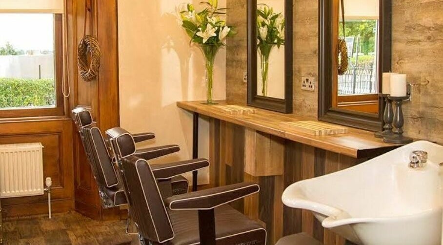 Elegant salon interior at Park West Spa, Hamilton, Scotland, GB featuring brown chairs and wooden decor.