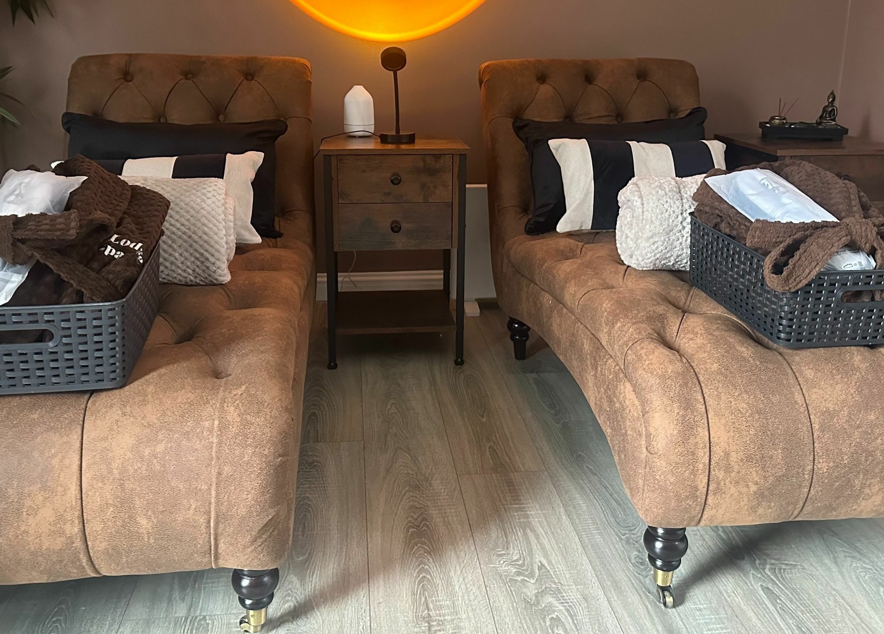 Dual loungers at Park West Spa, Hamilton, Scotland, GB, offer comfort with plush cushions and a warm ambiance.