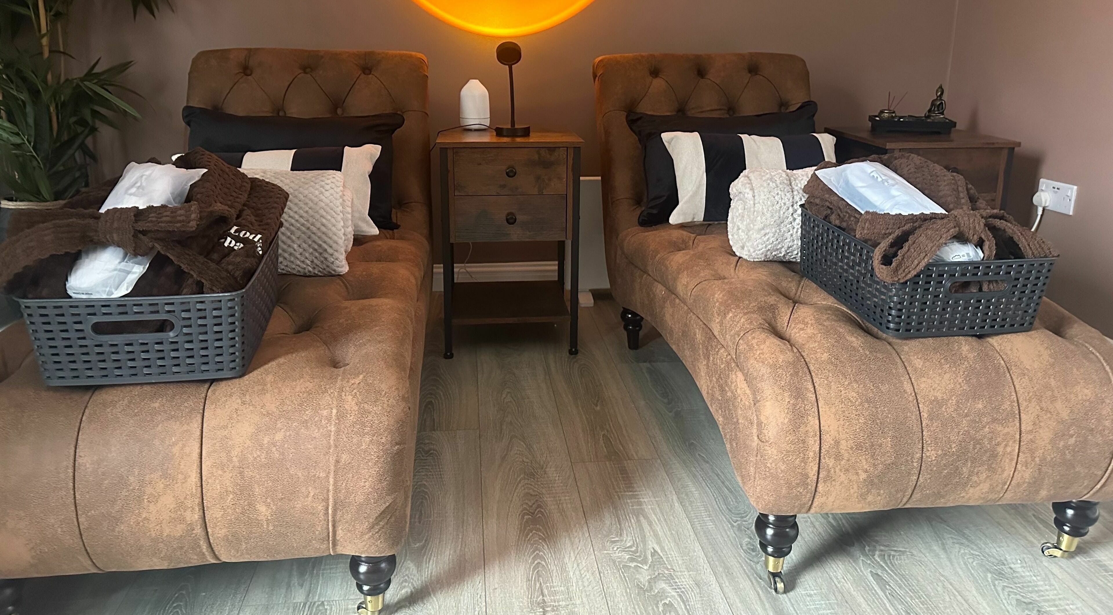 Dual loungers at Park West Spa, Hamilton, Scotland, GB, offer comfort with plush cushions and a warm ambiance.