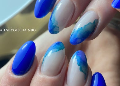 Stylish blue wave nail art from Nails by Giulia in London, England, GB, showcasing intricate design.