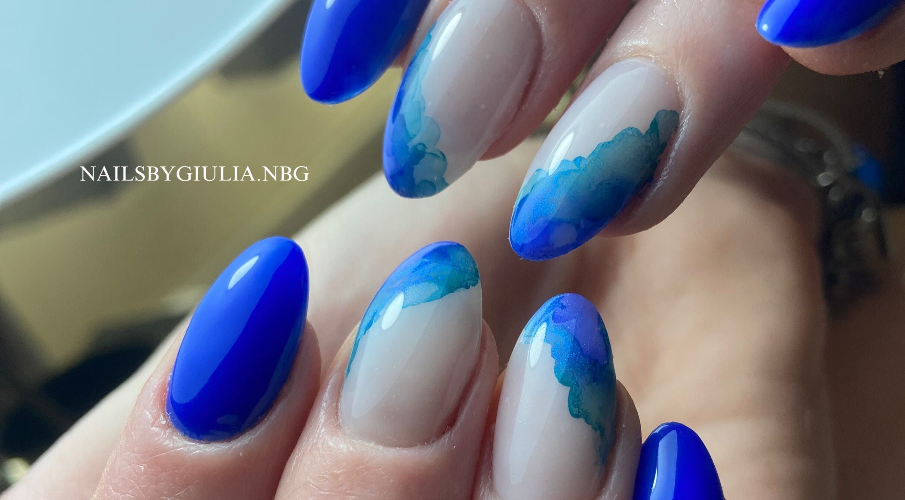 Stylish blue wave nail art from Nails by Giulia in London, England, GB, showcasing intricate design.