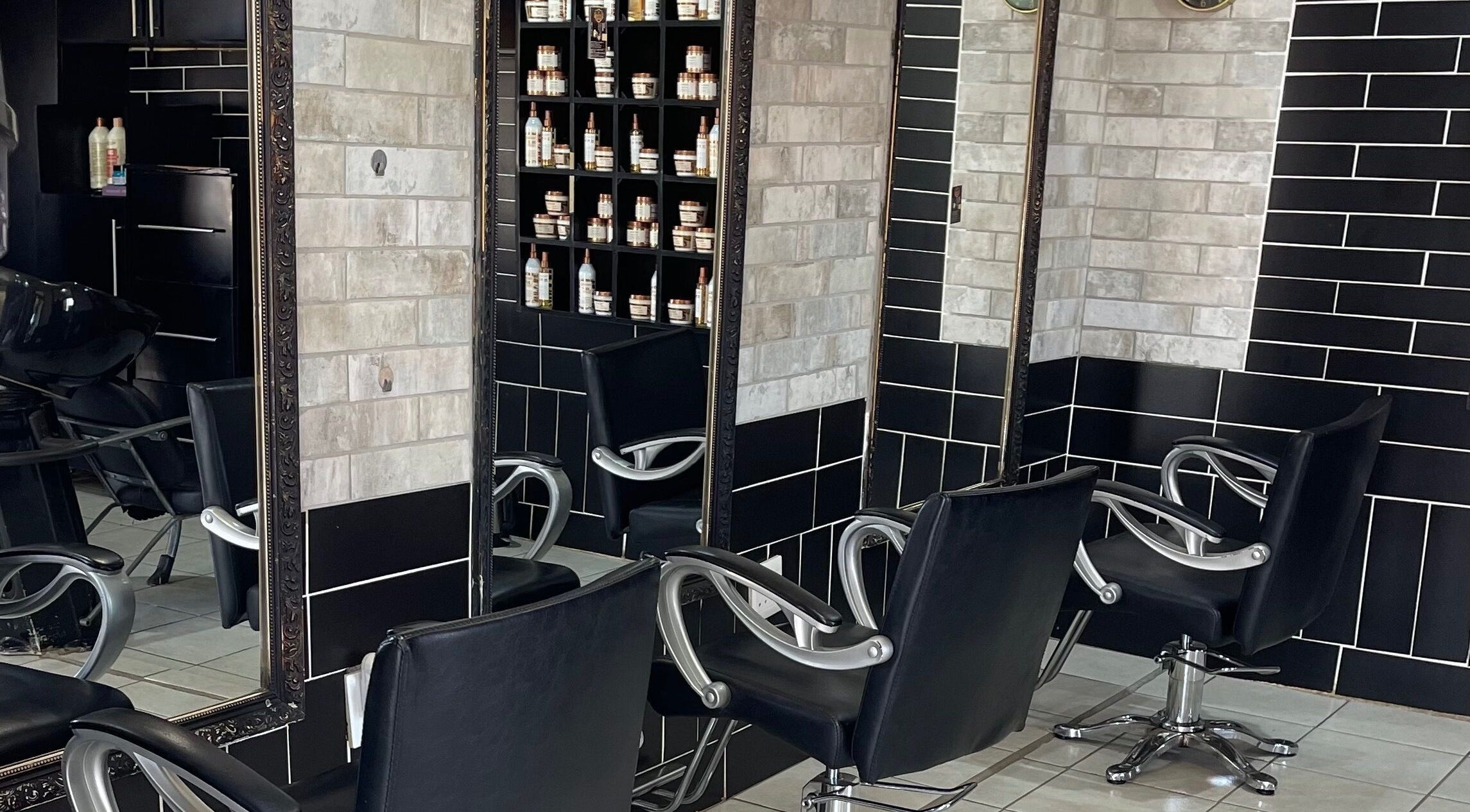 Elegant styling stations at Maharris Professional Salon in Pretoria, Gauteng, ZA with sleek black chairs.