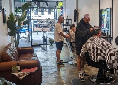 BSharp Barbershop interior in Melbourne, Victoria, AU featuring stylish haircuts and cozy seating.