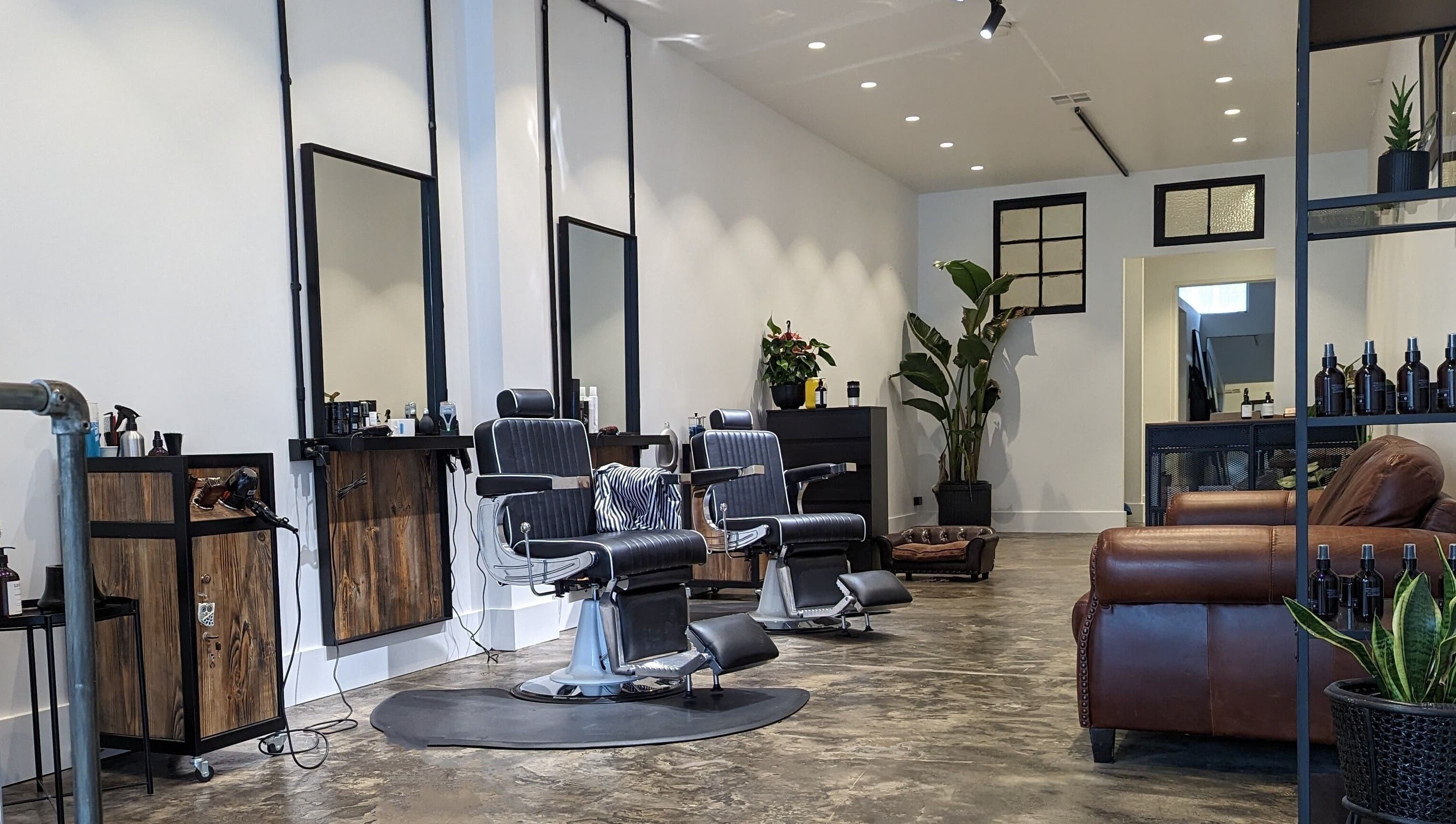 Elegant interior of BSharp Barbershop in Melbourne, Victoria, AU featuring modern chairs and rustic decor.