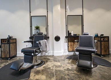 Stylish interior of BSharp Barbershop, Melbourne, Victoria, AU with sleek barber chairs and modern design.