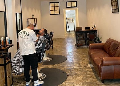 BSharp Barbershop interior, Melbourne, Victoria, AU. Barber and client in modern, welcoming styling area.