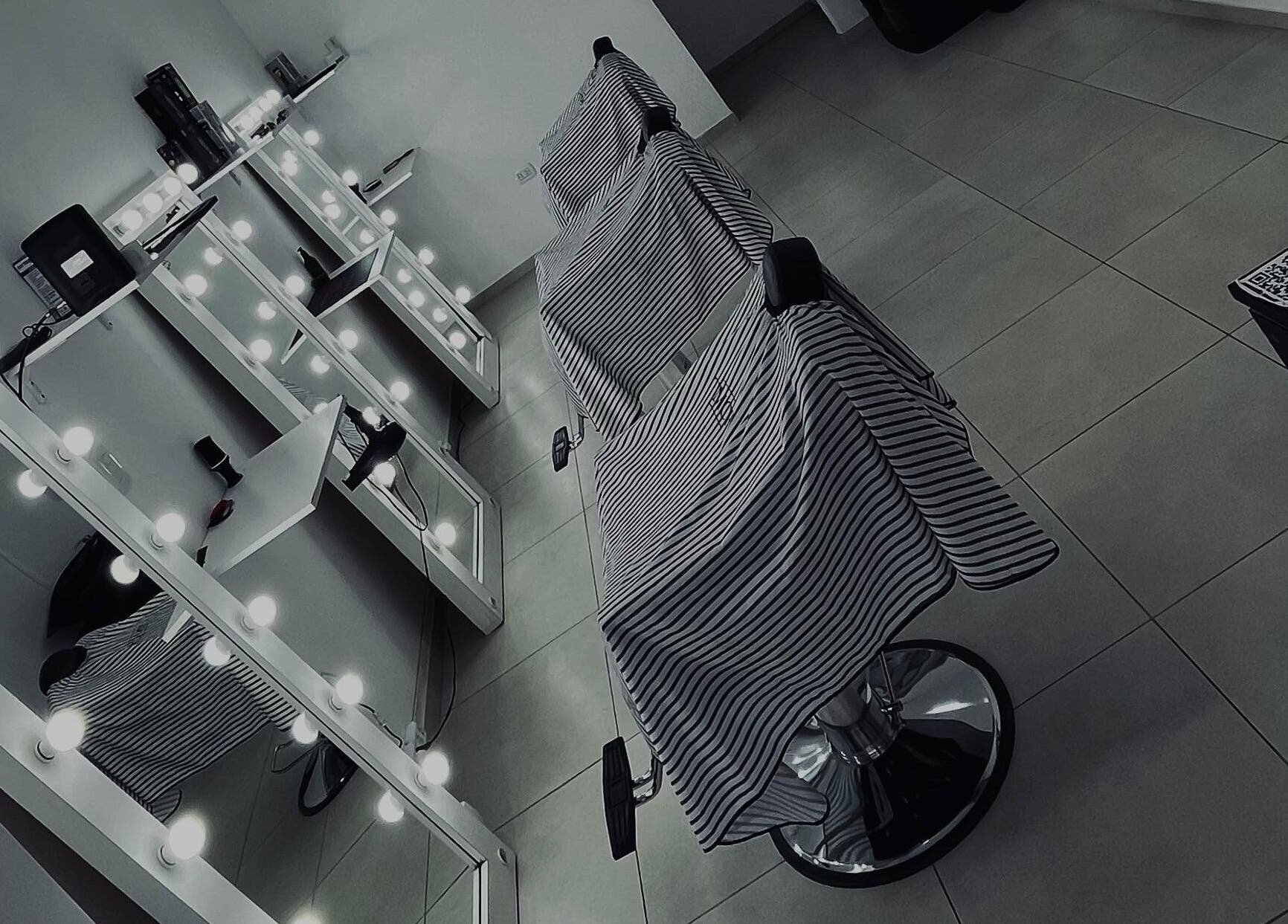 Interior de Blessed Barber en Concepción Del Uruguay, Entre Ríos, AR mostrando sillas y espejos iluminados.