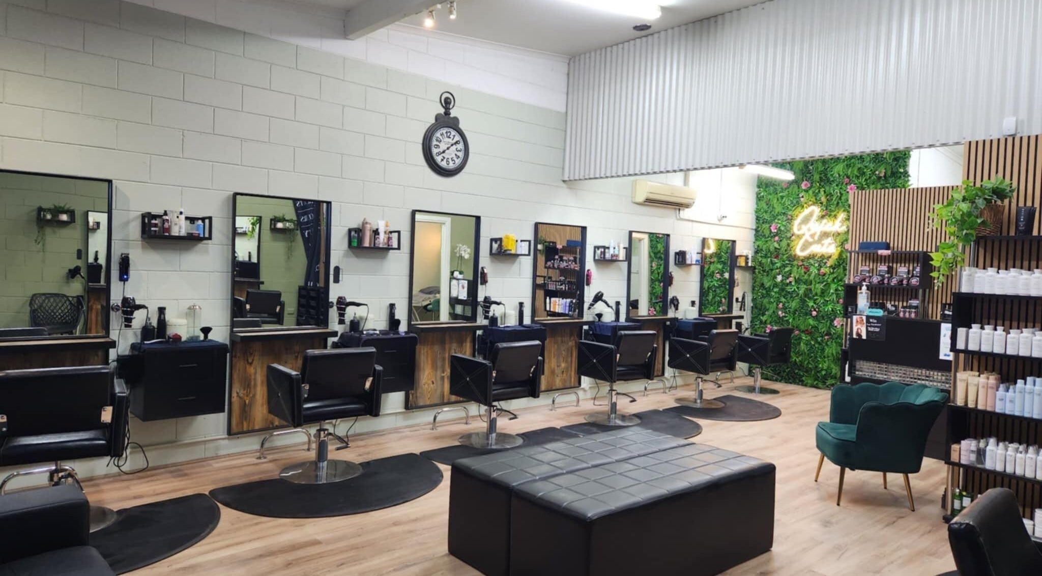 Spacious interior of Quick Cuts salon in Prospect, Tasmania, AU featuring modern styling stations and vibrant decor.