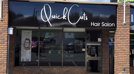 Front view of Quick Cuts hair salon, Prospect, Tasmania, AU with signage and glass windows.