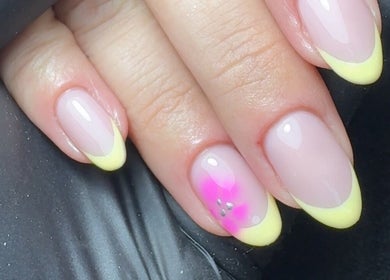 Yellow-tipped nails with a pink floral design at CE BEAUTY STUDIO, Southampton, England, GB.