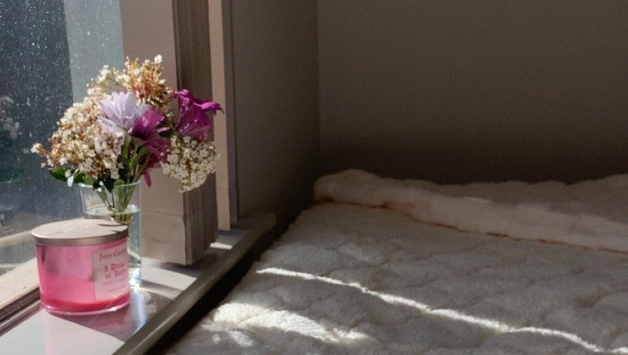 Warm sunlight on cozy bed with flowers at Dolled Up By Lily, Kelmscott, Western Australia, AU.